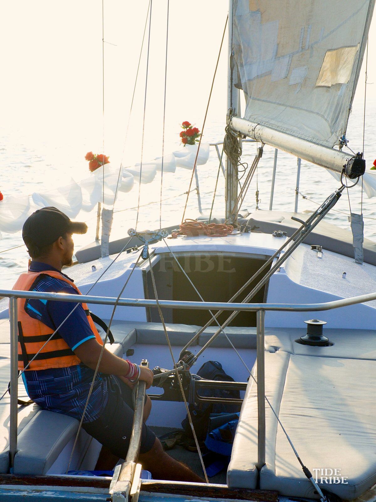 A Tide Tribe sailor at the helm