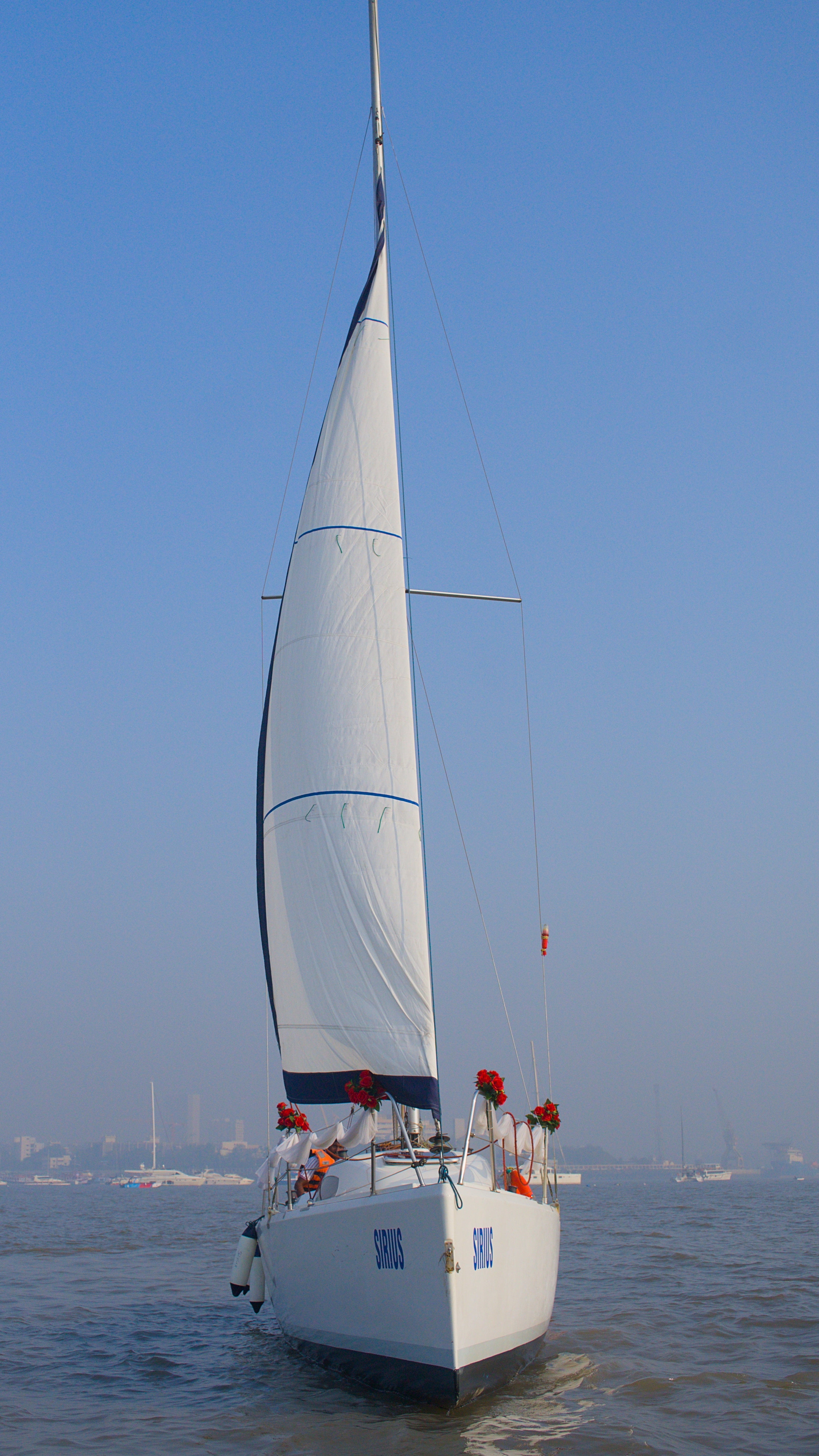 Sailboat on the water with a clear blue sky