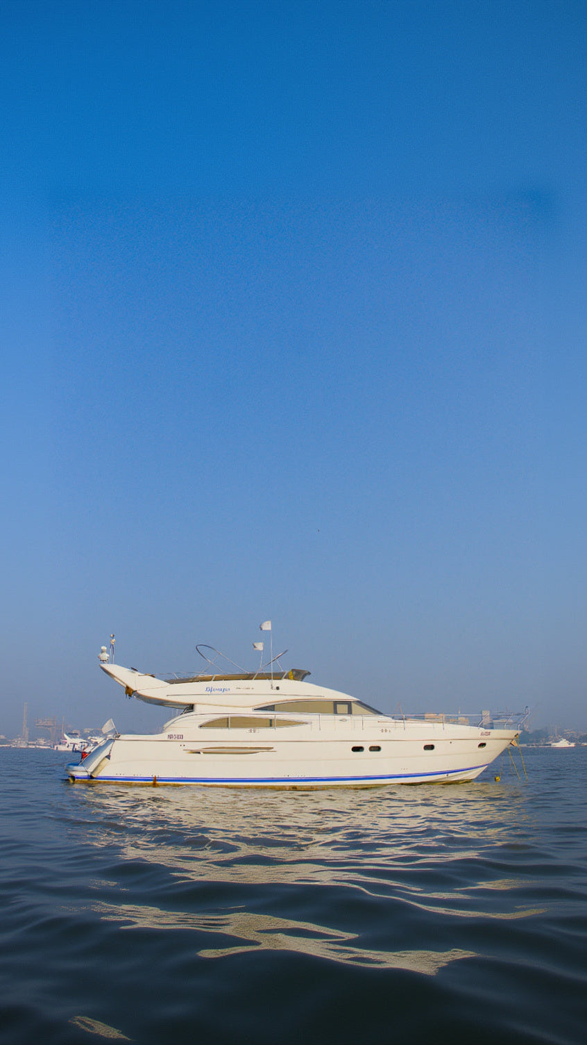 White yacht on water with clear blue sky