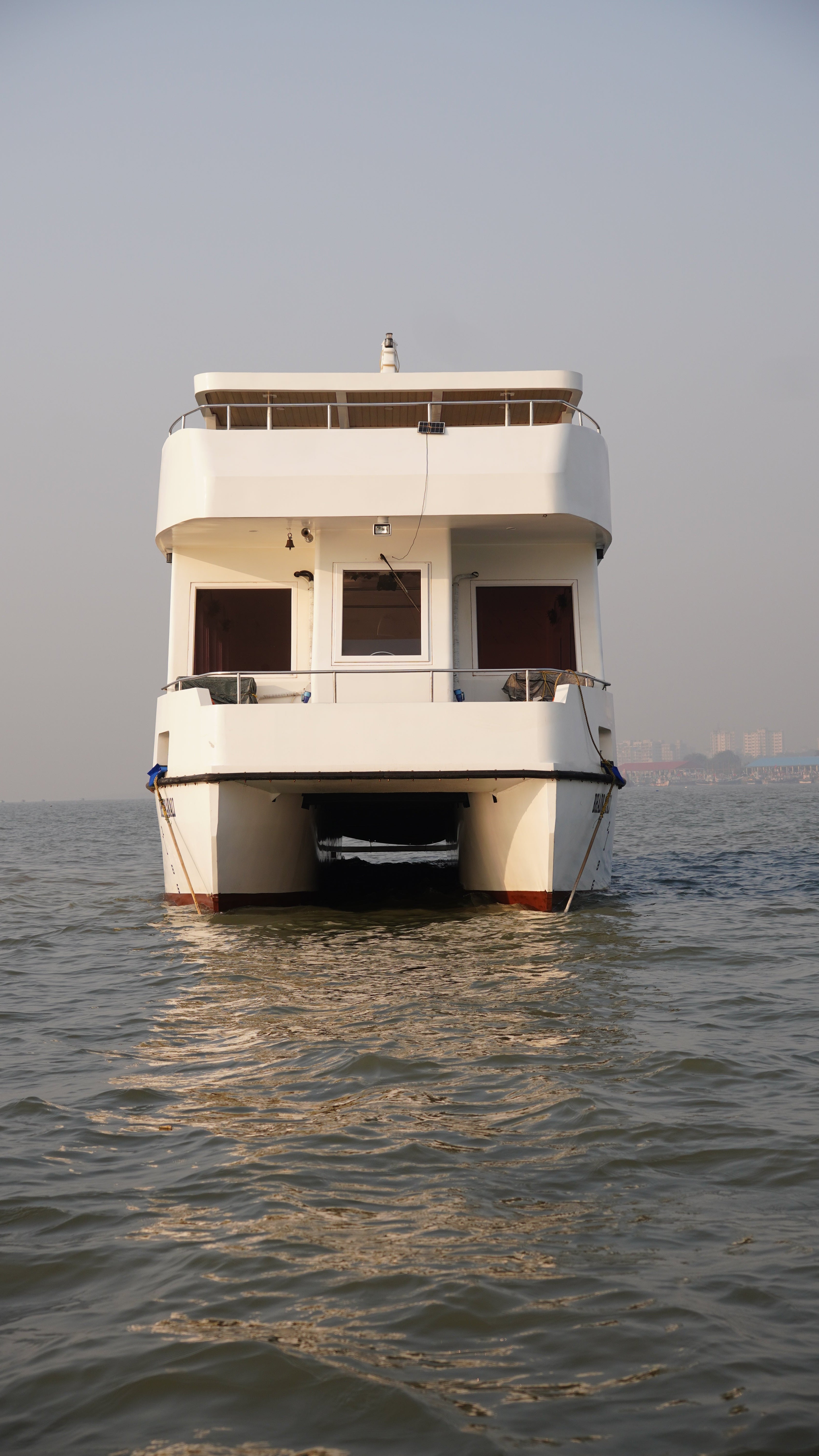 Reflective surface showing a building's reflection with water and sky.